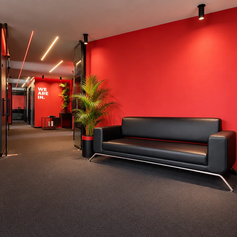 Black leather sofa in the red lounge